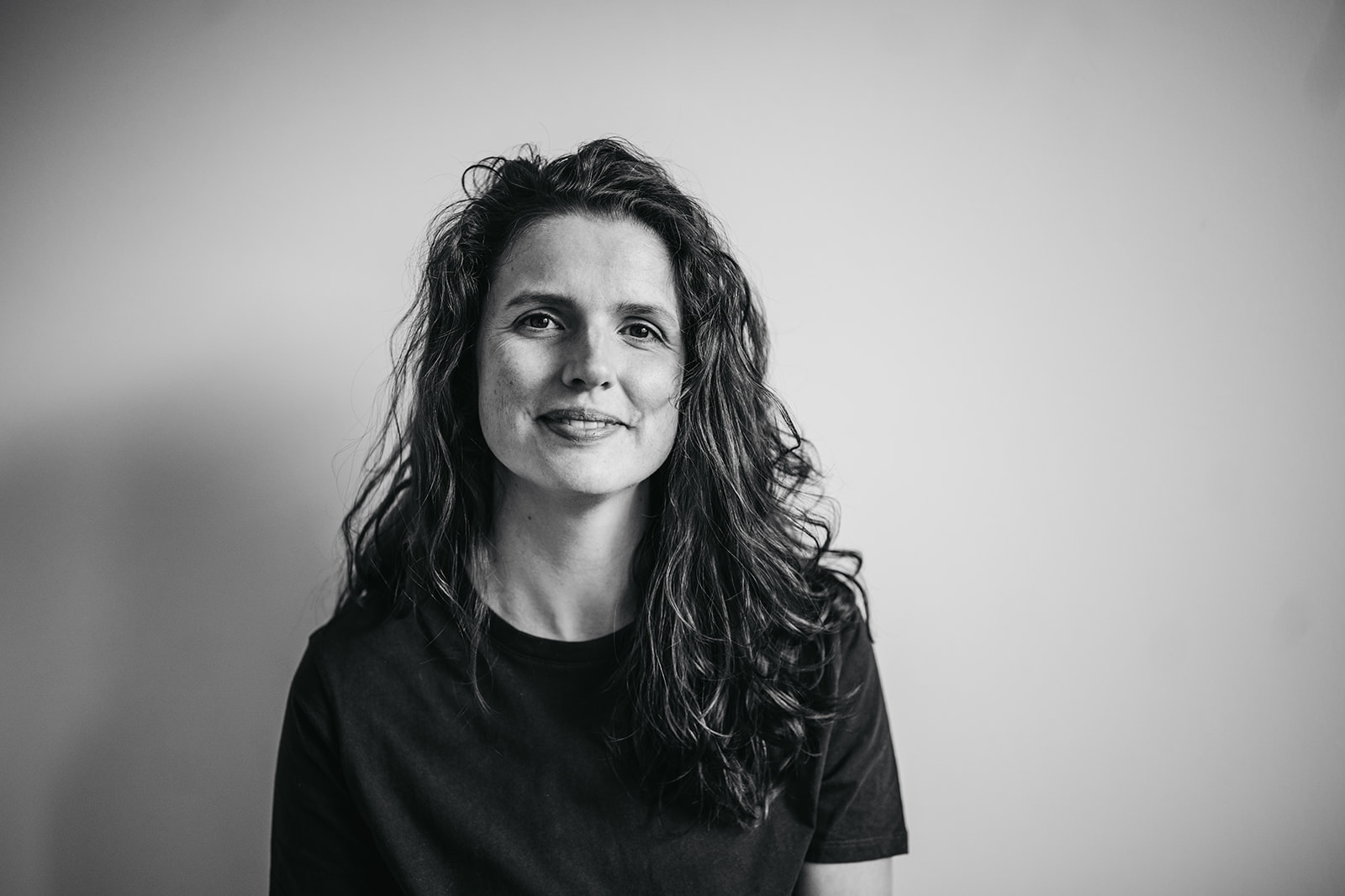 a black and white image of a woman in a t-shirt.